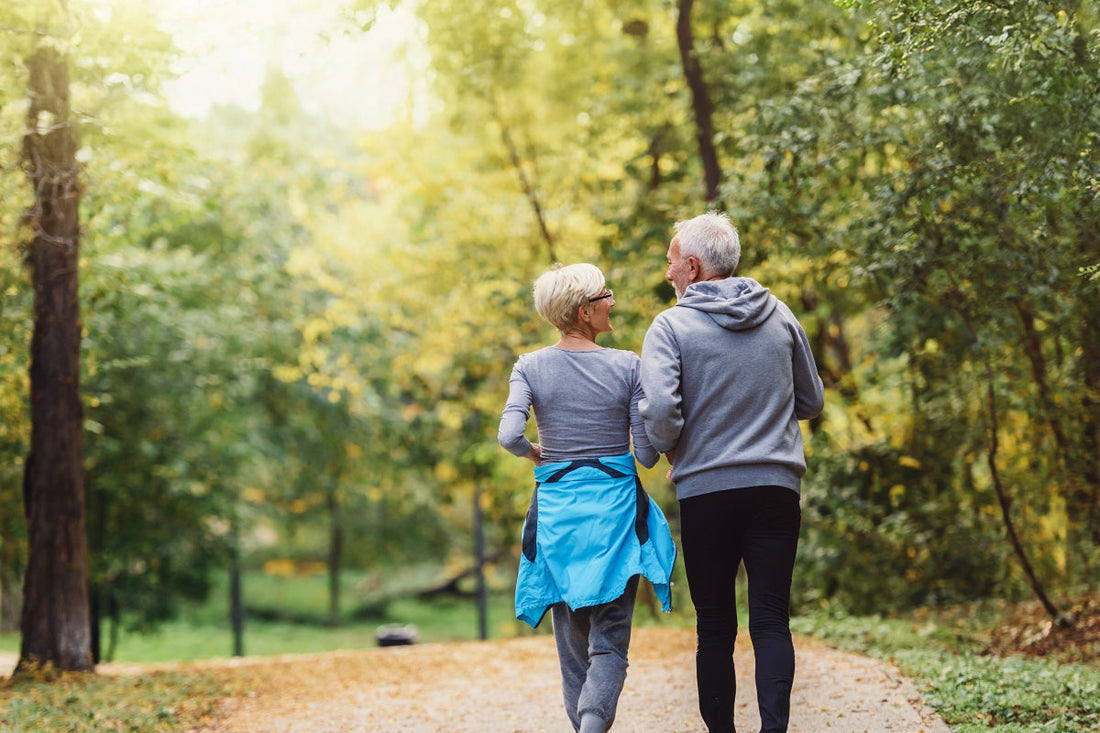 A couple of seniors running together in nature